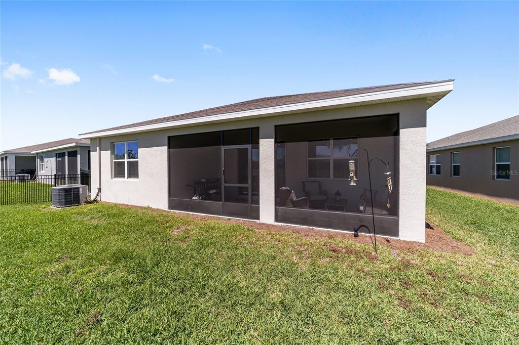 5252 Northwest 46th Lane Road Ocala, FL 34482 - Photo 49 of 51 a front view of a house with a yard and garage