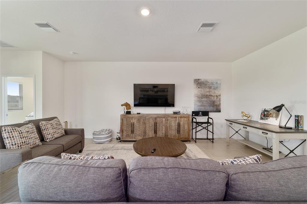 5252 Northwest 46th Lane Road Ocala, FL 34482 - Photo 10 of 51 a living room with furniture and a flat screen tv