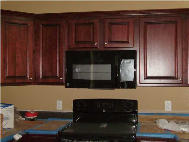 311 Dahlquist Drive Crestview, FL 32539 - Photo 3 of 14 a kitchen with wooden cabinets and a stove top oven