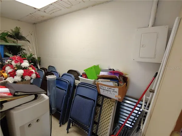 a large room with lots of chairs and wooden furniture