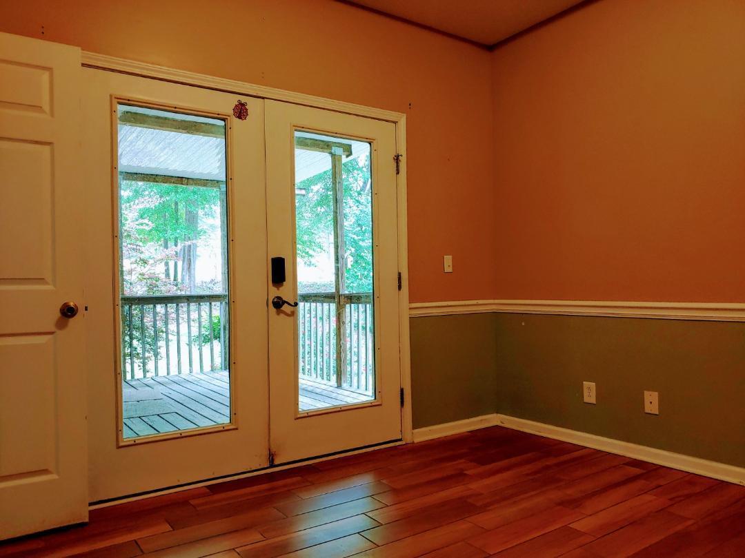 7531 Goodall Mill Road Macon, GA 31216 - Photo 3 of 16 an empty room with wooden floor and windows