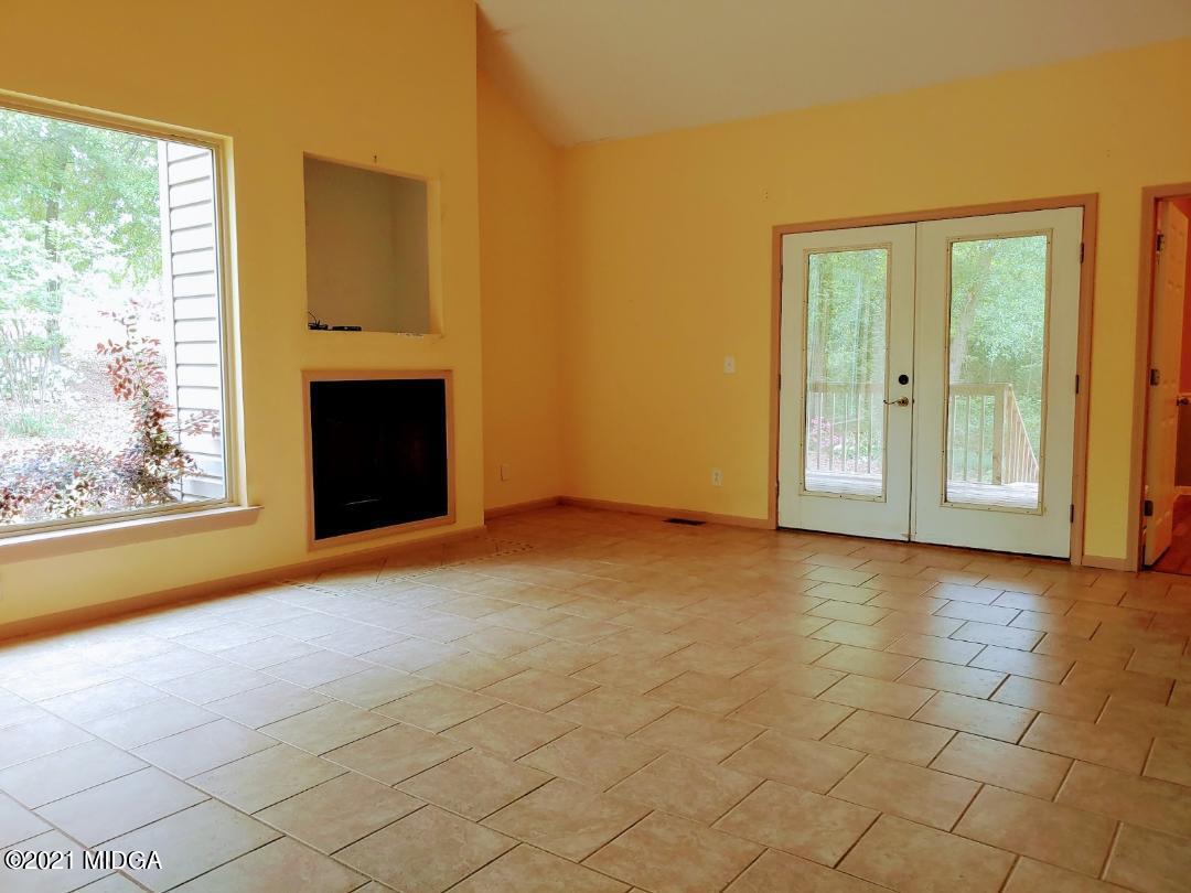 7531 Goodall Mill Road Macon, GA 31216 - Photo 7 of 16 an empty room with windows and fireplace