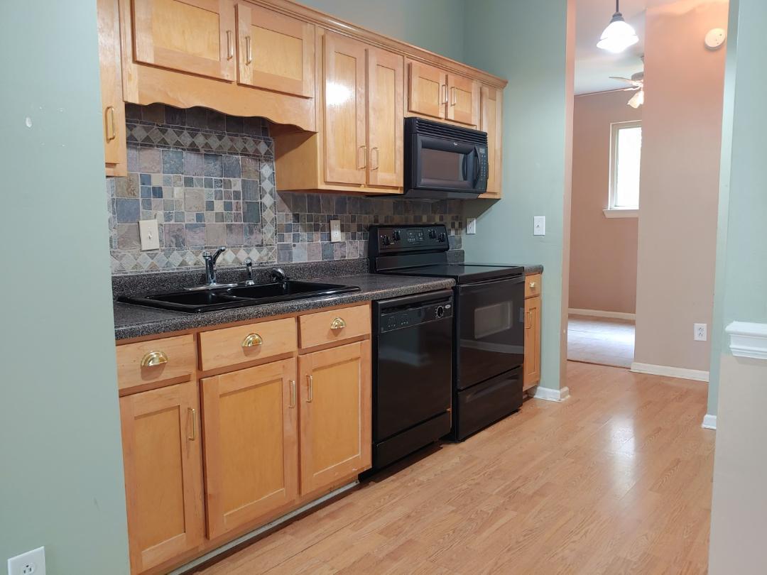 7531 Goodall Mill Road Macon, GA 31216 - Photo 9 of 16 a kitchen with stainless steel appliances granite countertop a sink stove and microwave