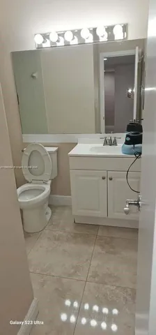 a bathroom with a sink a toilet and mirror