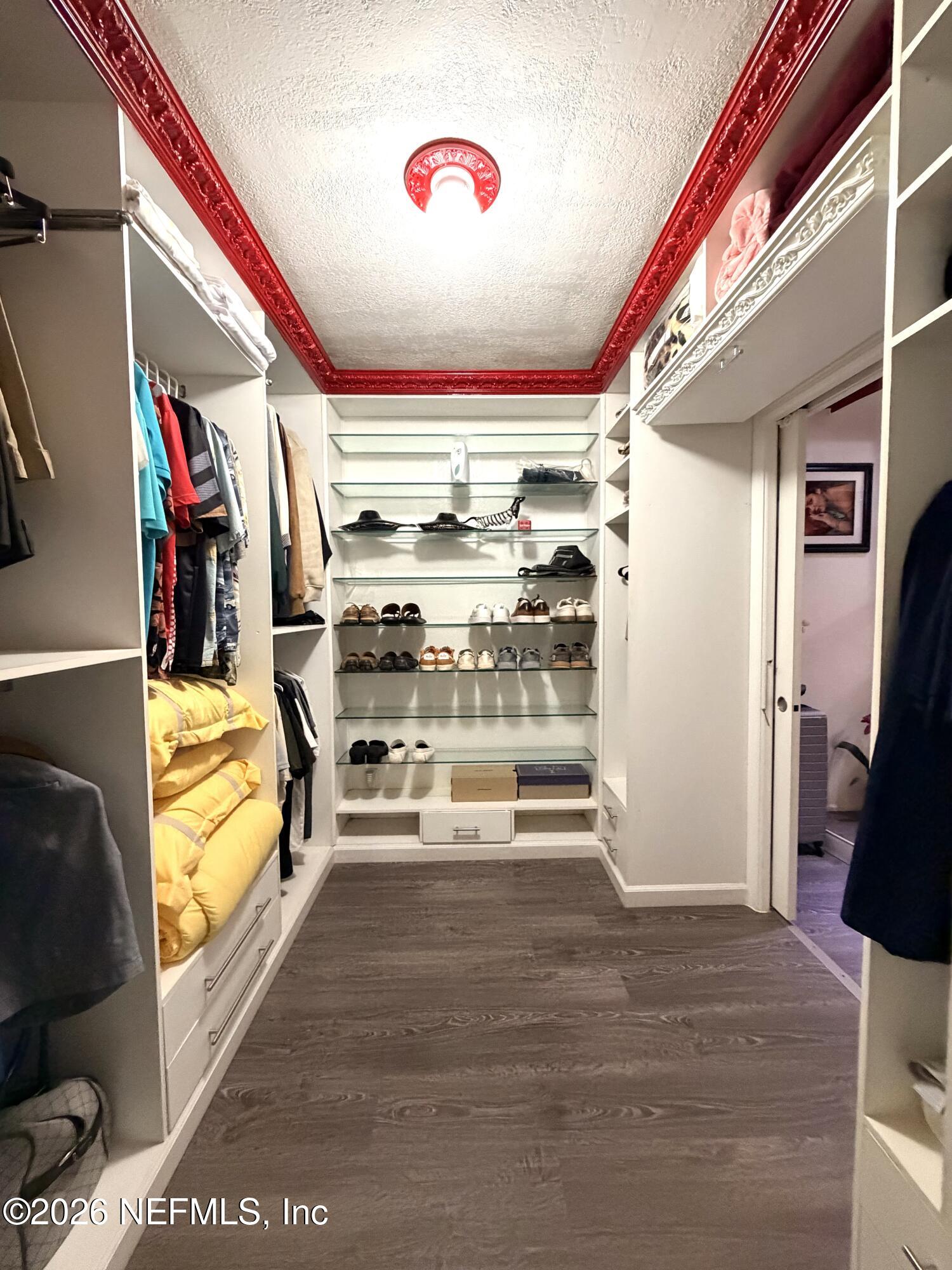 4127 Springwood Road Jacksonville, FL 32207 - Photo 27 of 63 a view of walk in closet with clothes and shoes