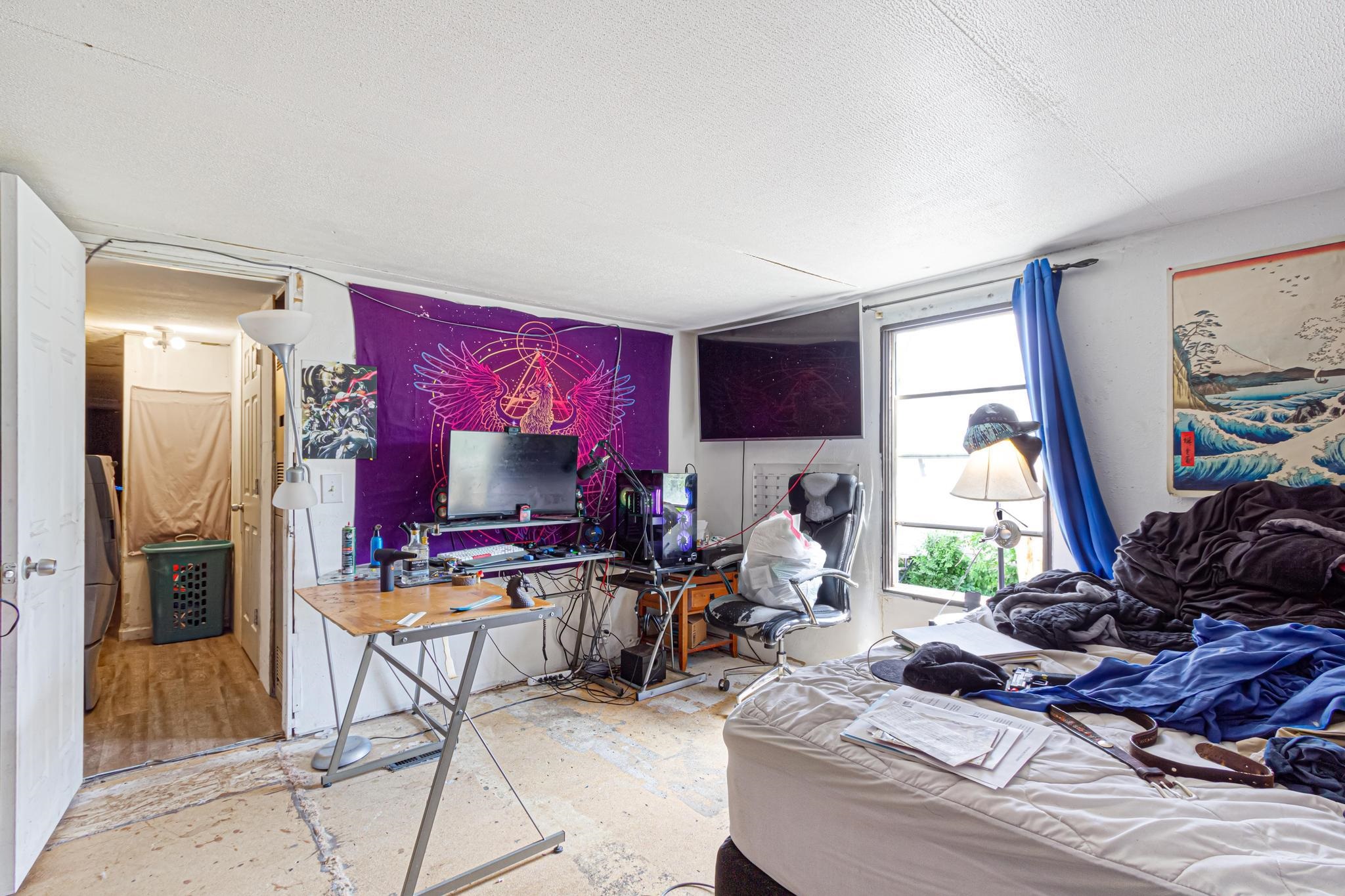 3268 E Road, Unit 1 Clifton, CO 81520 - Photo 13 of 17 a living room with furniture a window and a flat screen tv