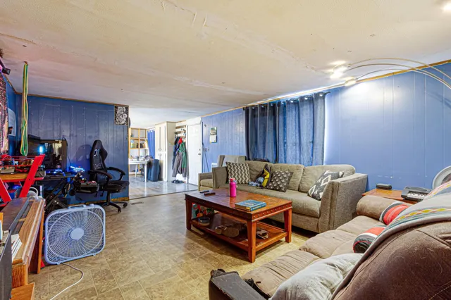 a living room with furniture a couch and large window