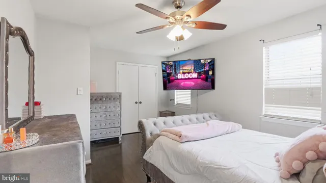 a bedroom with a bed dresser and a window