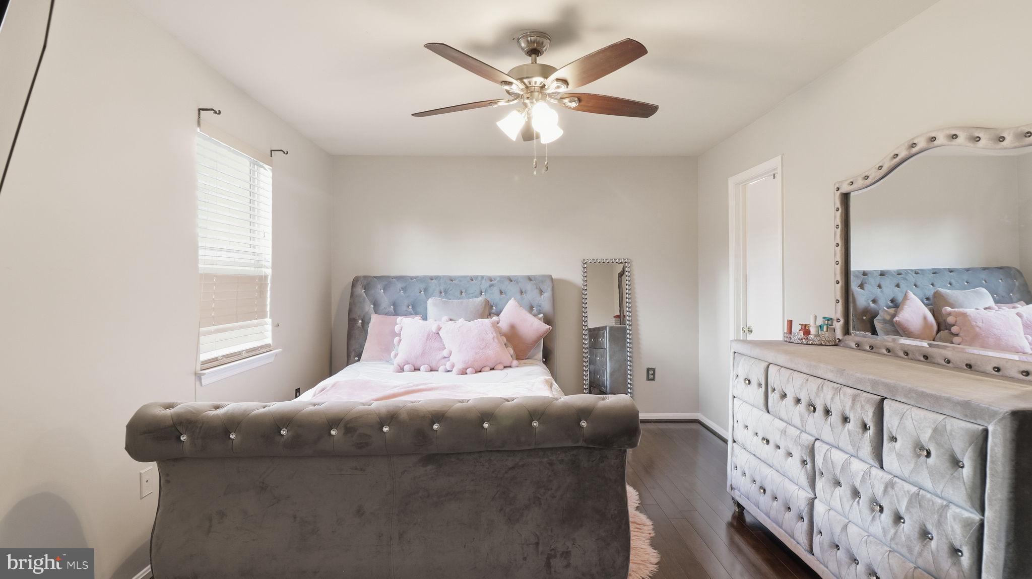 7631 South Arbory Lane, Unit 360 Laurel, MD 20707 - Photo 15 of 25 a bedroom with a large bed and a chandelier