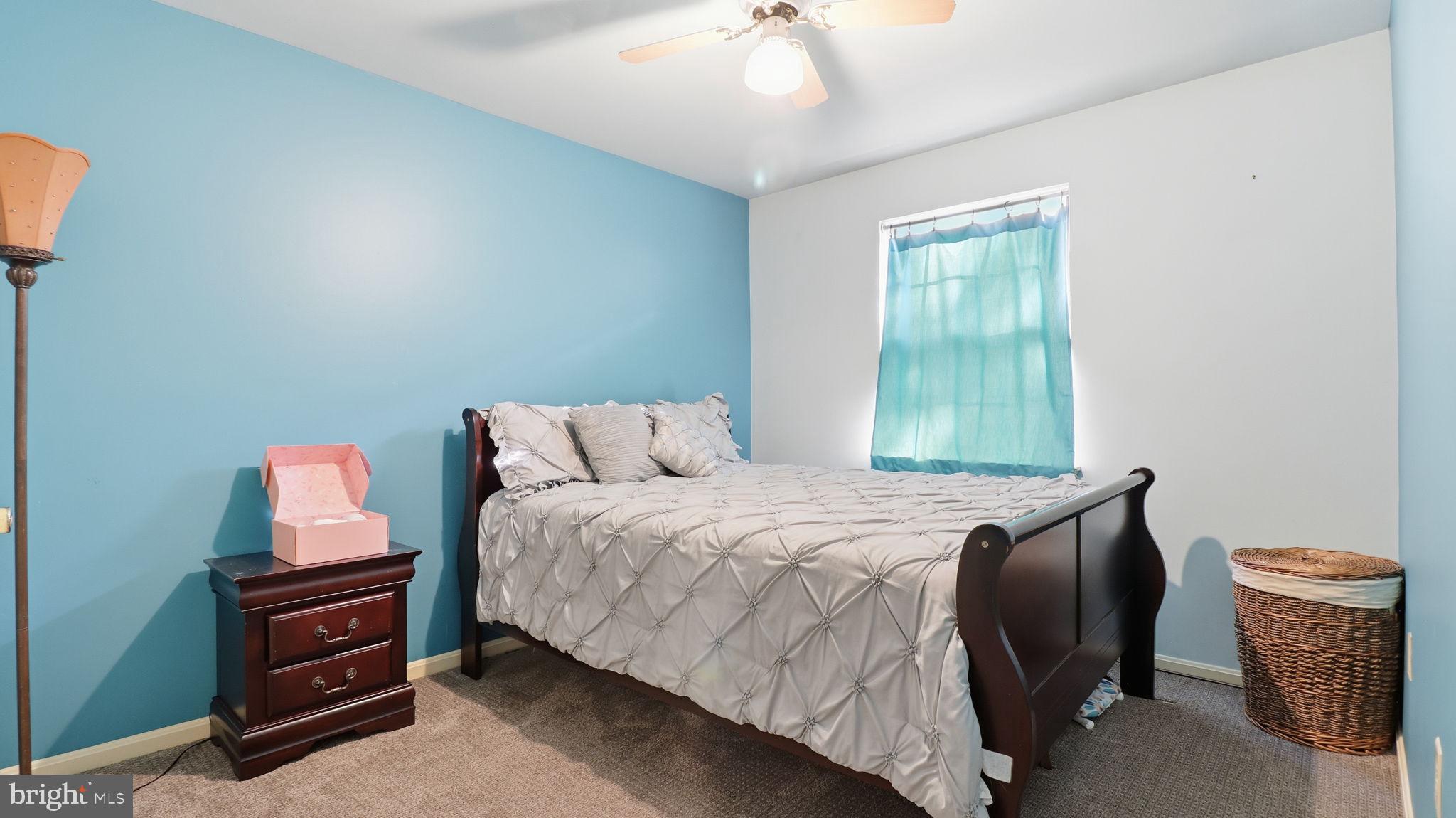 7631 South Arbory Lane, Unit 360 Laurel, MD 20707 - Photo 19 of 25 a bedroom with a bed and a chandelier