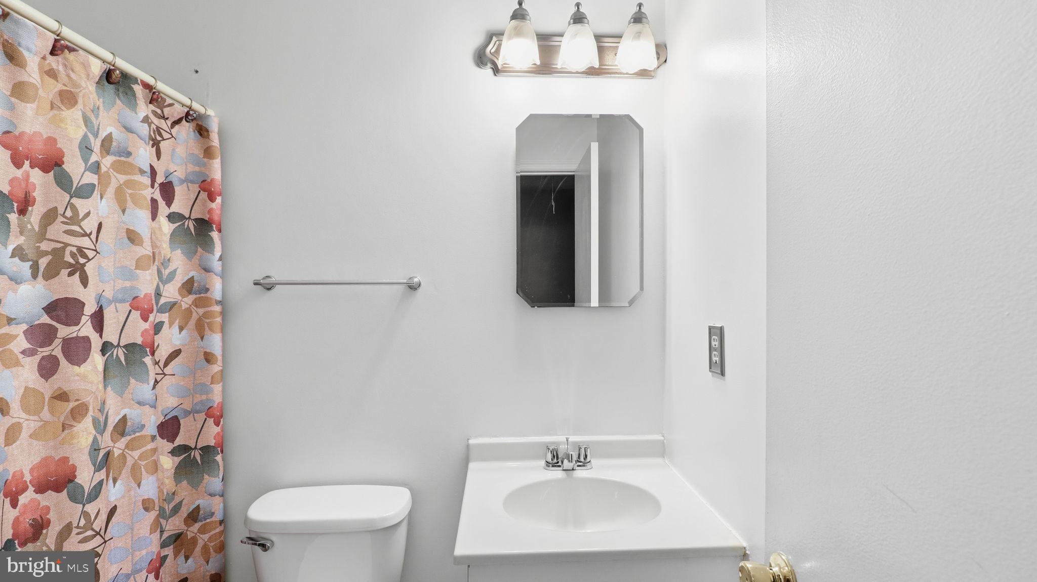 7631 South Arbory Lane, Unit 360 Laurel, MD 20707 - Photo 20 of 25 a bathroom with a toilet sink and mirror