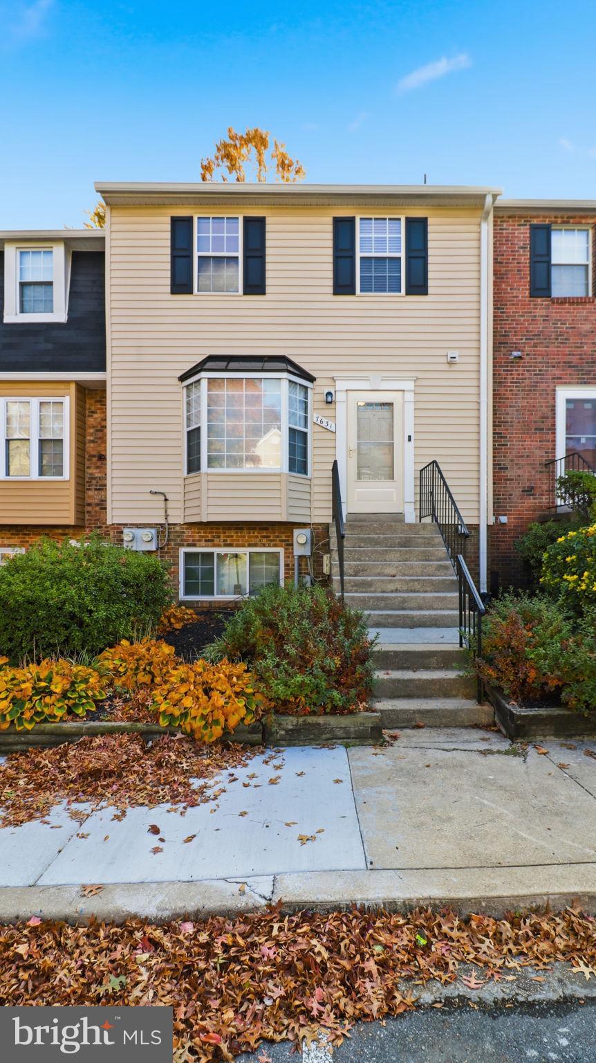 7631 South Arbory Lane, Unit 360 Laurel, MD 20707 - Photo 2 of 25 a front view of a house with garden