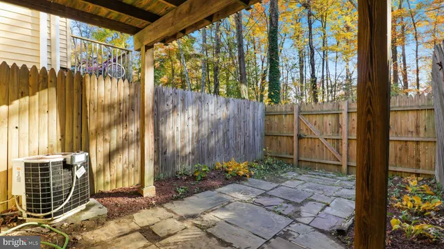 a view of a pathway gate with wooden fence
