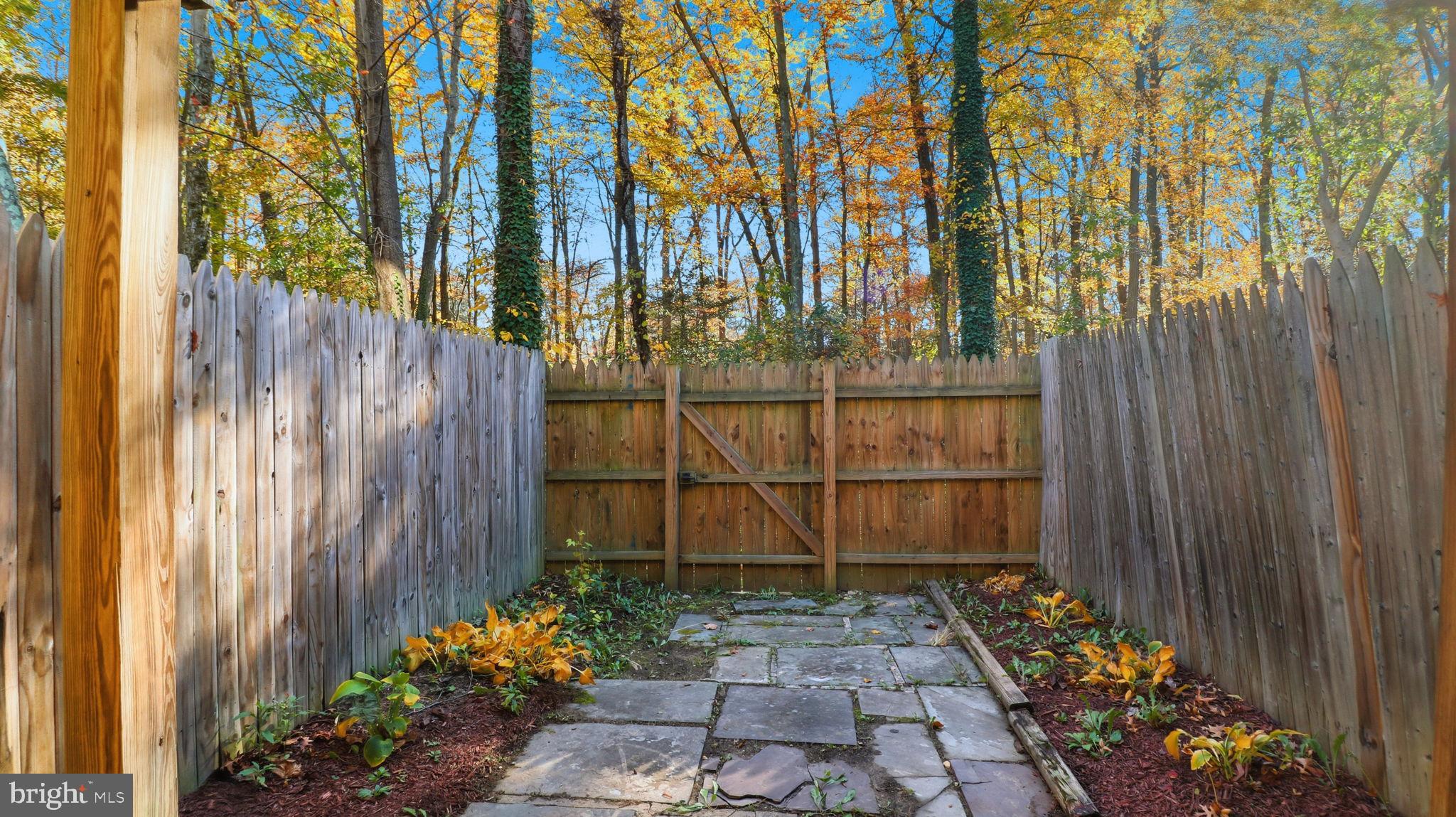 7631 South Arbory Lane, Unit 360 Laurel, MD 20707 - Photo 25 of 25 a view of a pathway gate with wooden fence