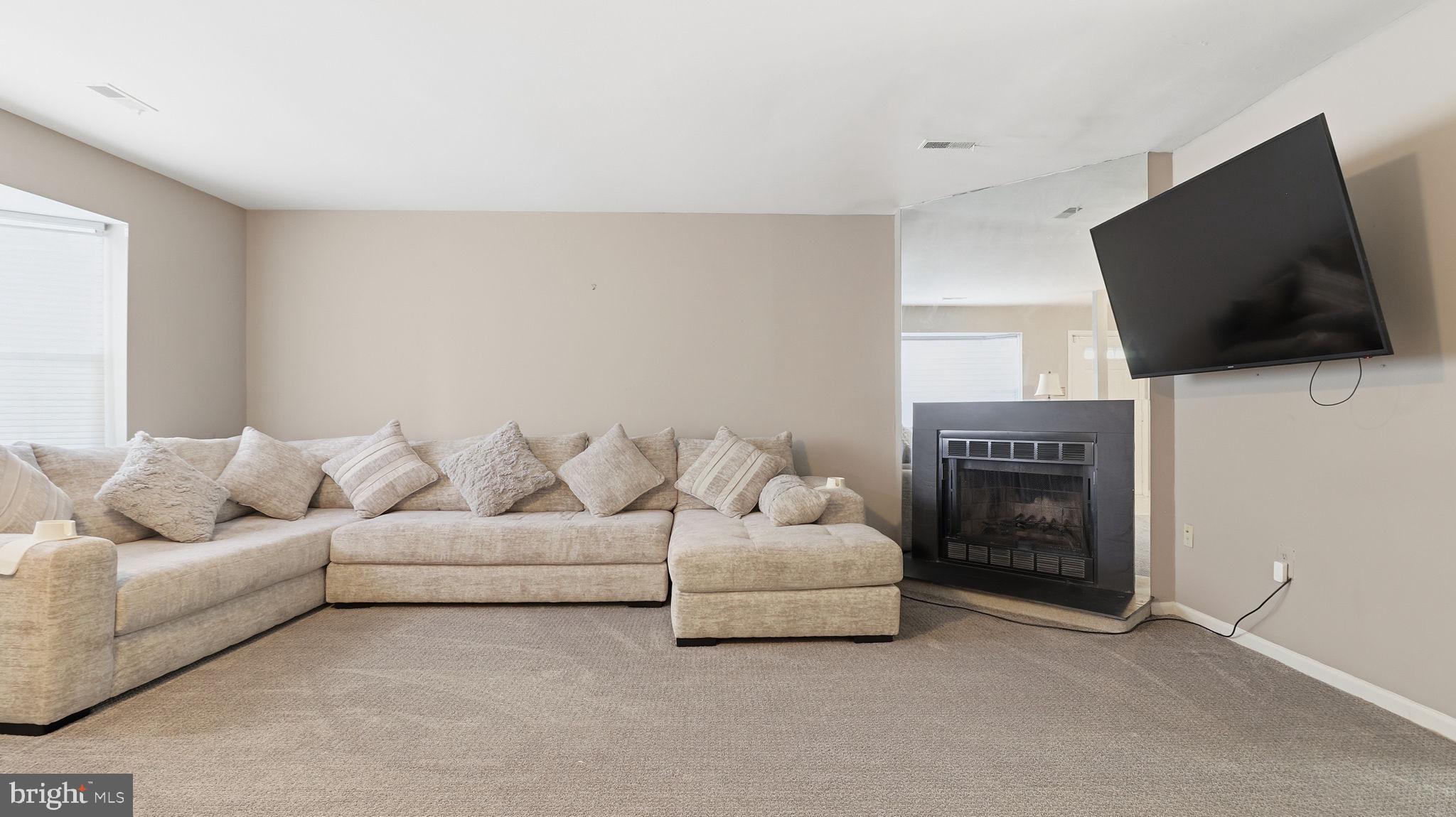 7631 South Arbory Lane, Unit 360 Laurel, MD 20707 - Photo 4 of 25 a living room with furniture and a flat screen tv