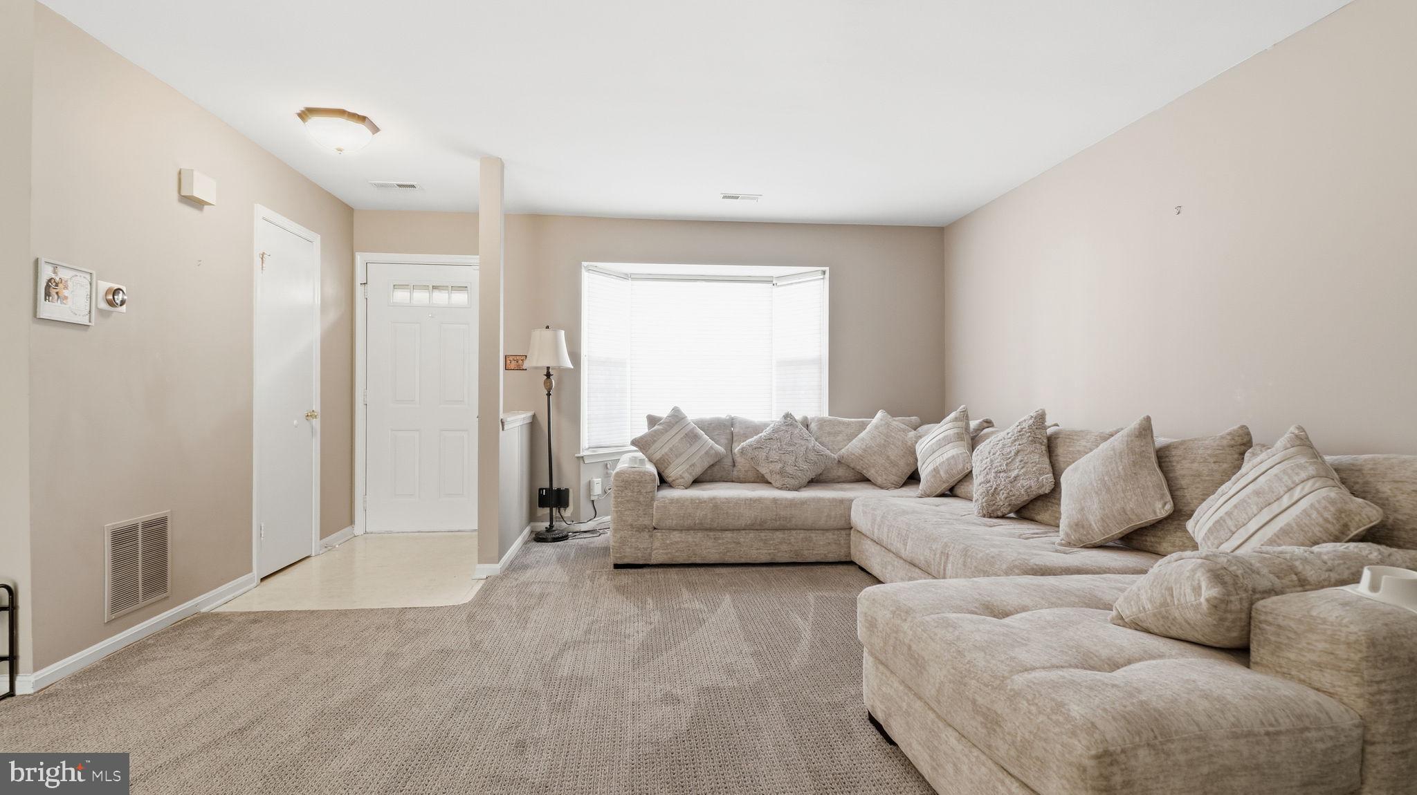 7631 South Arbory Lane, Unit 360 Laurel, MD 20707 - Photo 5 of 25 a living room with furniture and a large window