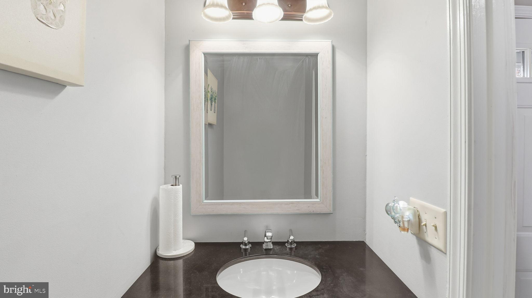 7631 South Arbory Lane, Unit 360 Laurel, MD 20707 - Photo 6 of 25 a bathroom with a sink and a mirror