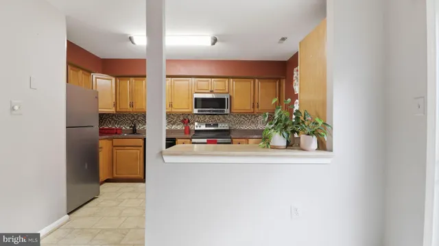 a kitchen with stainless steel appliances a refrigerator and a stove