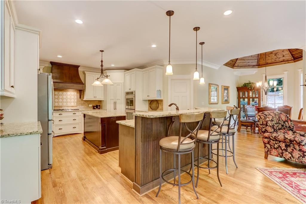 5807 Bison Drive Oak Ridge, NC 27310 - Photo 13 of 39 Lots of cabinets, upgraded appliances, pendant lighting, under counter lighting, raised barn but open to great room.