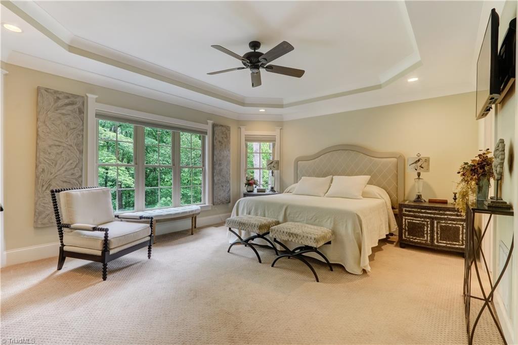 5807 Bison Drive Oak Ridge, NC 27310 - Photo 17 of 39 Large owner's suite is neutral tones with great natural light and views.