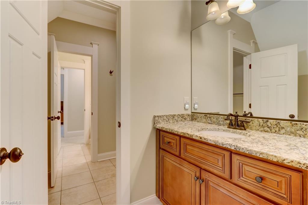 5807 Bison Drive Oak Ridge, NC 27310 - Photo 25 of 39 One of the three alternate baths , tile floors and granite countertops.