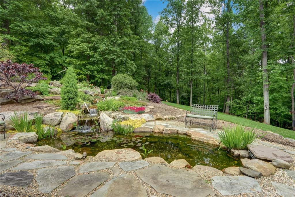 5807 Bison Drive Oak Ridge, NC 27310 - Photo 8 of 39 Another view of the secluded rear yard with water feature.