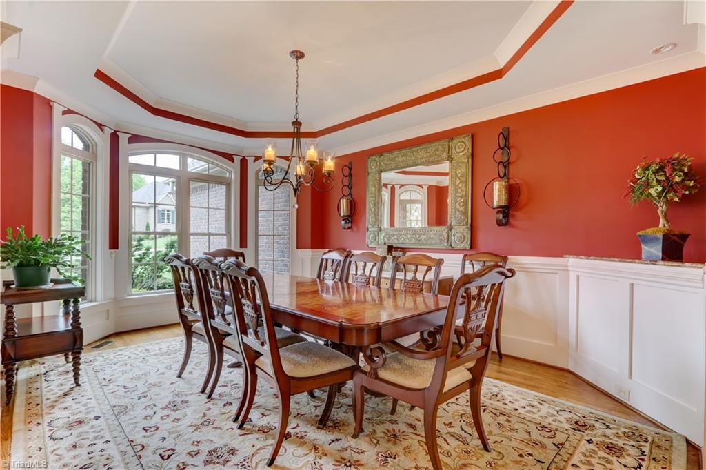 5807 Bison Drive Oak Ridge, NC 27310 - Photo 10 of 39 Dining Room with octagon tray ceiling and wainscoting.