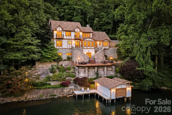 a front view of house with yard and lake view