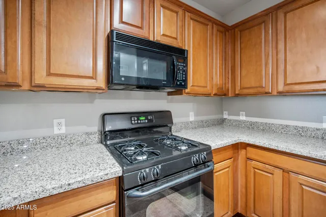 wooden floor in an empty room with a chandelier fan
