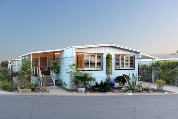 a front view of a house with a yard and outdoor seating