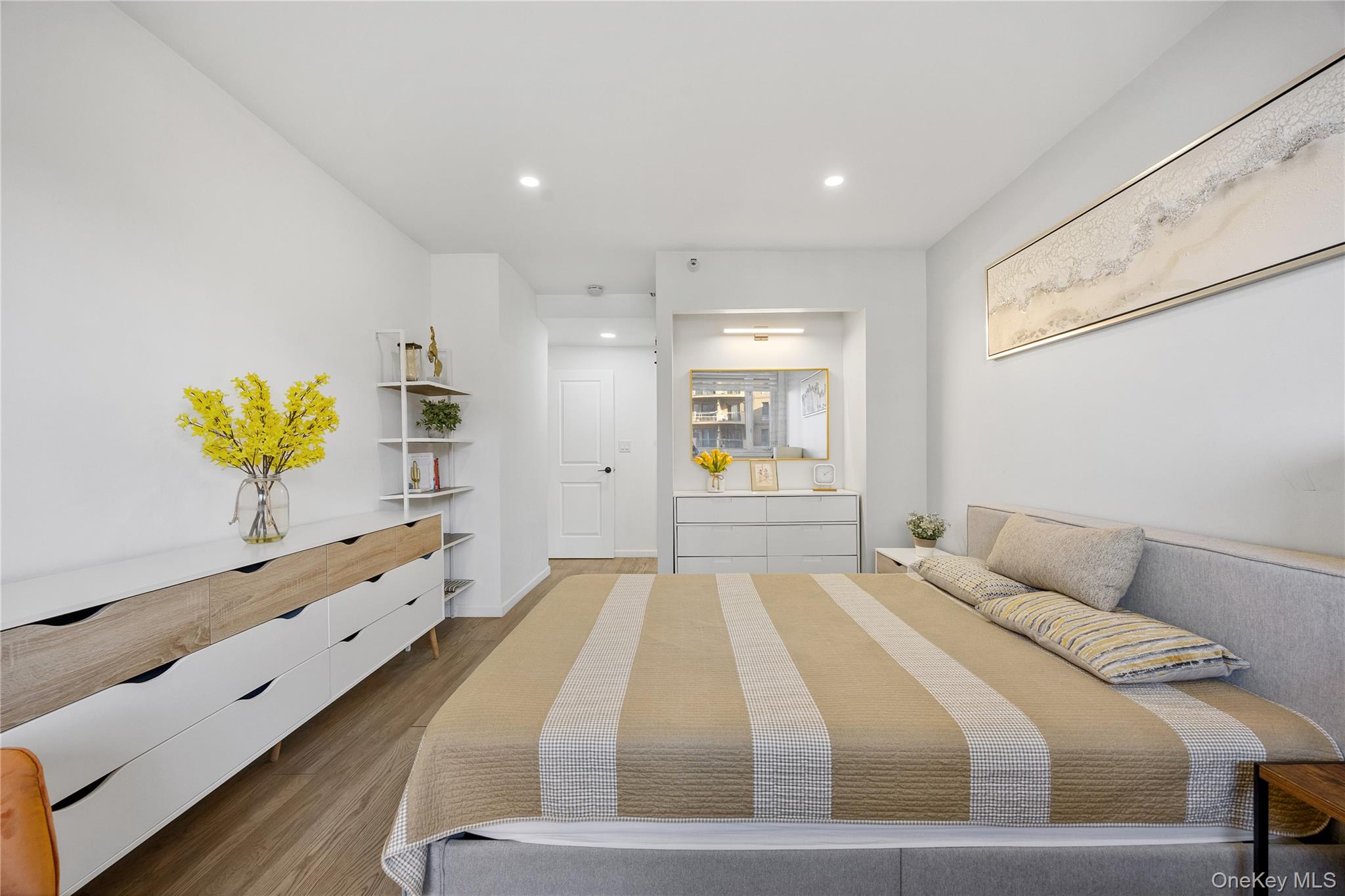 133-38 Sanford Avenue, Unit 6C Queens, NY 11355 - Photo 9 of 21 a bedroom with a bed and a dresser