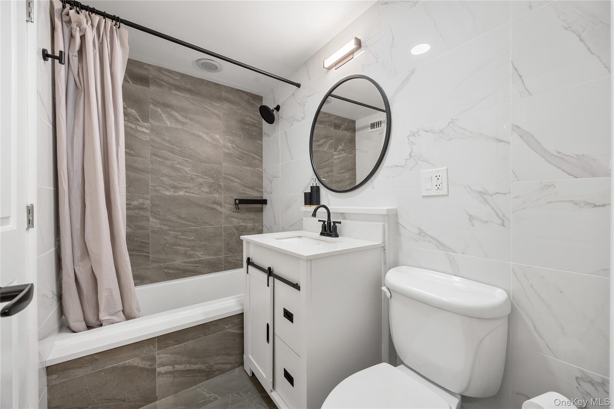 133-38 Sanford Avenue, Unit 6C Queens, NY 11355 - Photo 10 of 21 a bathroom with a sink toilet and a mirror