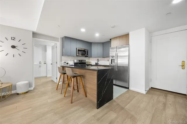 a kitchen with stainless steel appliances kitchen island granite countertop a sink and cabinets