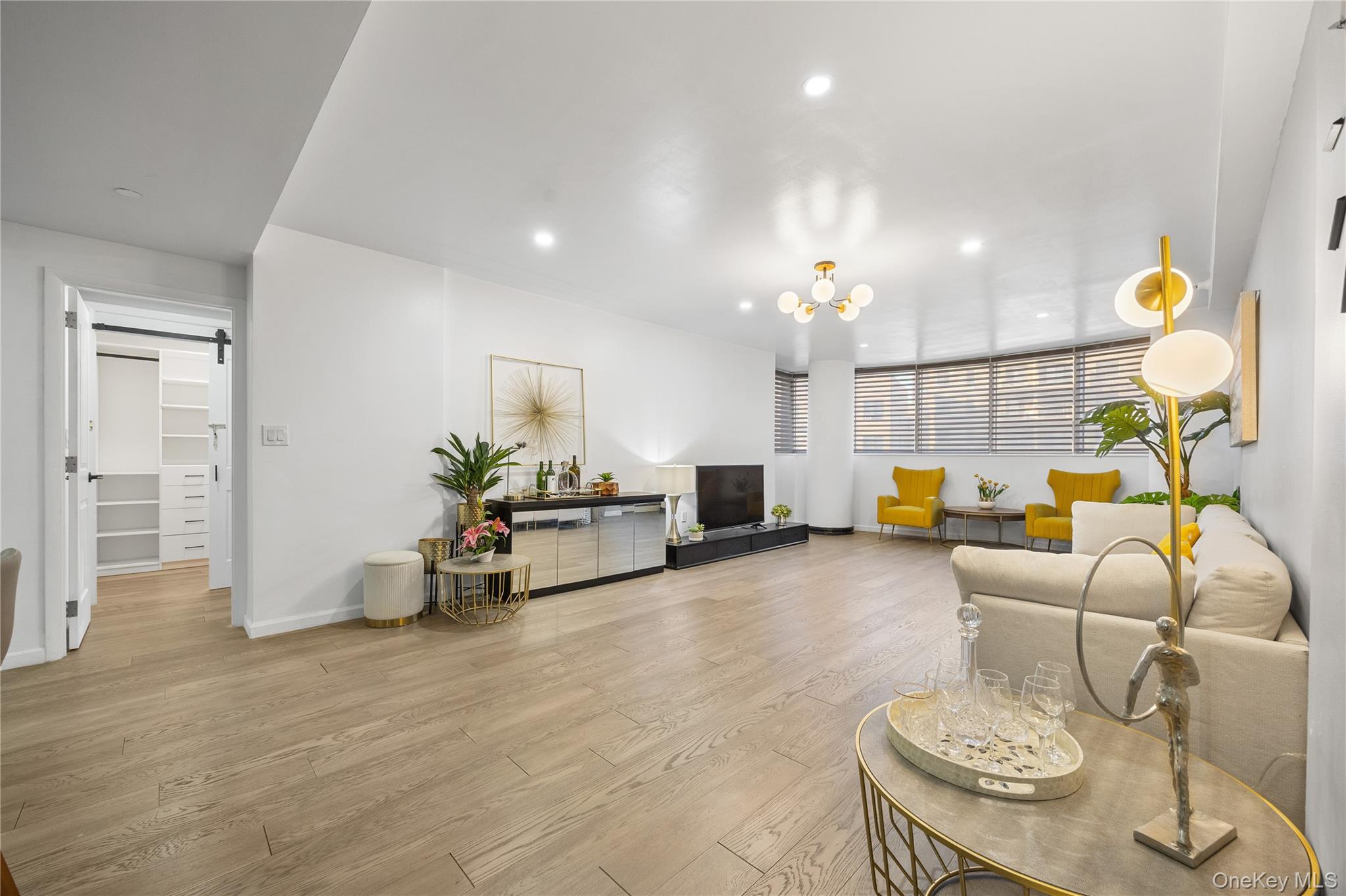 133-38 Sanford Avenue, Unit 6C Queens, NY 11355 - Photo 4 of 21 a living room with furniture and a chandelier