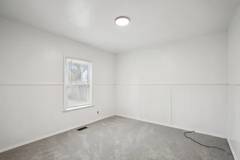 an empty room with a empty space and windows