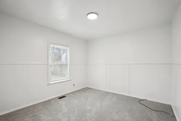 an empty room with a empty space and windows