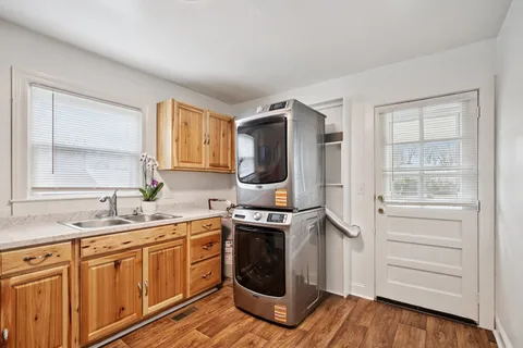 a kitchen with a sink stove and cabinets