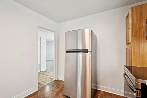 a view of walk in closet with wooden floor