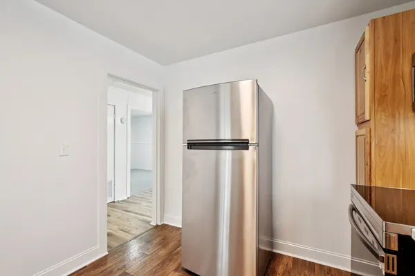 a view of walk in closet with wooden floor