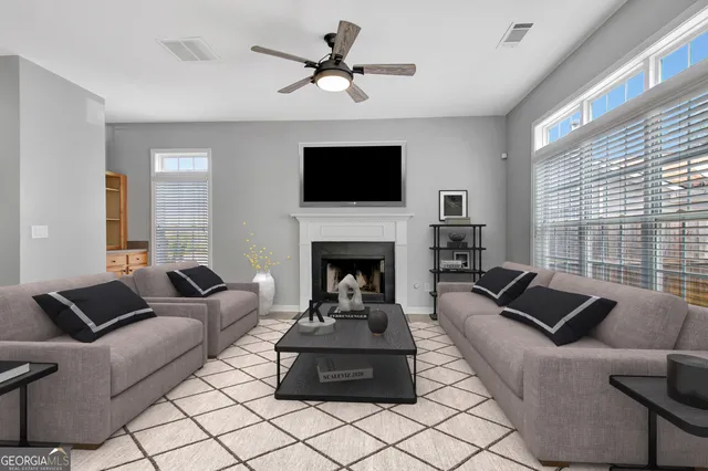 a living room with furniture fireplace and window