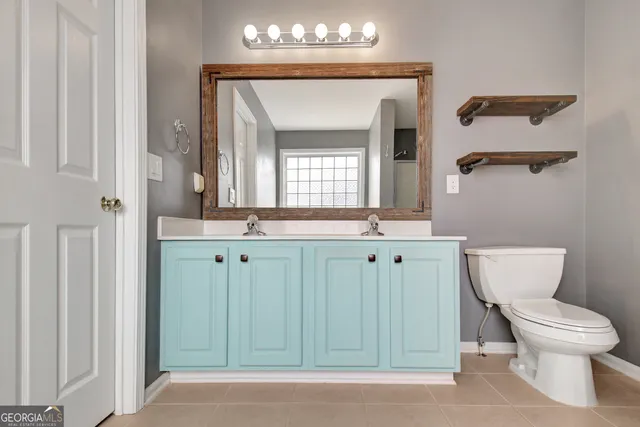 a bathroom with a toilet a sink and a mirror