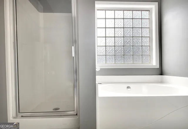 a bathroom with a bathtub and a window