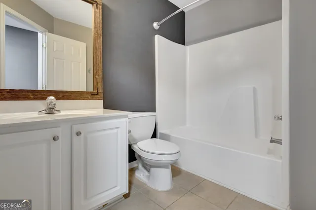 a bathroom with a sink toilet and a mirror