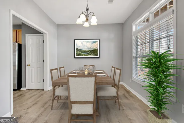 a view of a dining room with furniture window and wooden floor