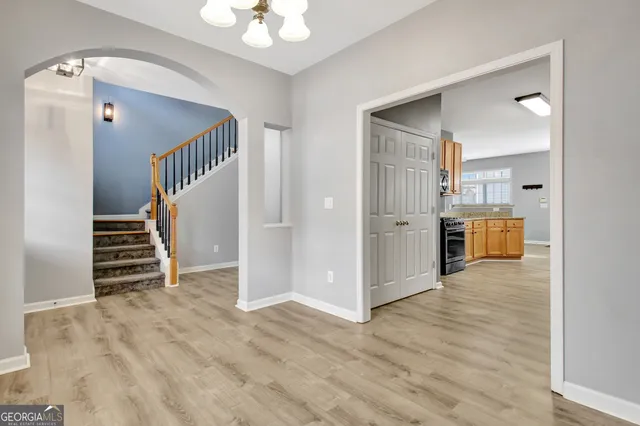 a view of a kitchen with wooden floor and entryway