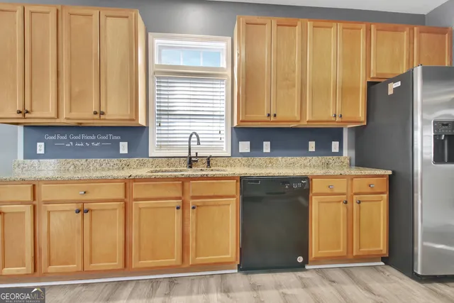 a kitchen with stainless steel appliances granite countertop a refrigerator and cabinets