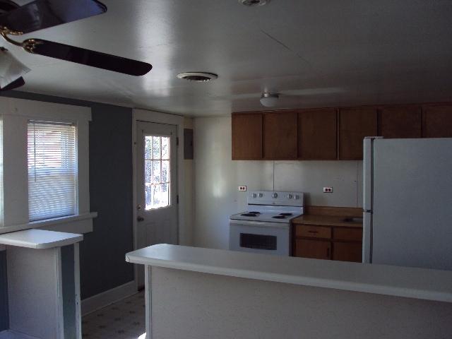 2068 Shockley Springs Road Baker, FL 32531 - Photo 4 of 5 a kitchen with stainless steel appliances a stove a refrigerator and a more cabinets