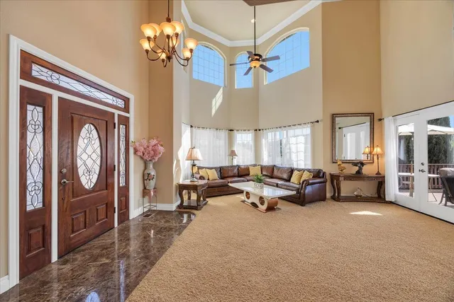 a view of a livingroom with furniture and a ceiling fan