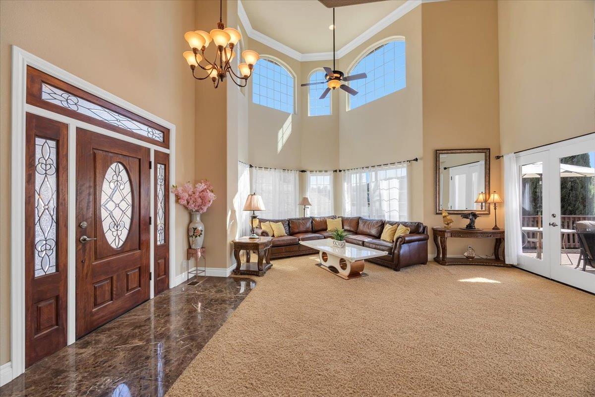 294 Sunrise Road, Unit 2 Copperopolis, CA 95228 - Photo 12 of 98 a living room with furniture a chandelier and a large window