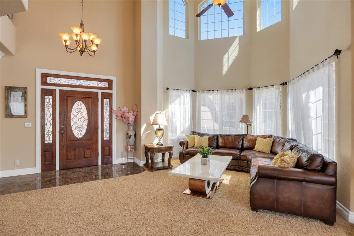 294 Sunrise Road, Unit 2 Copperopolis, CA 95228 - Photo 13 of 98 a living room with furniture a chandelier and a large window